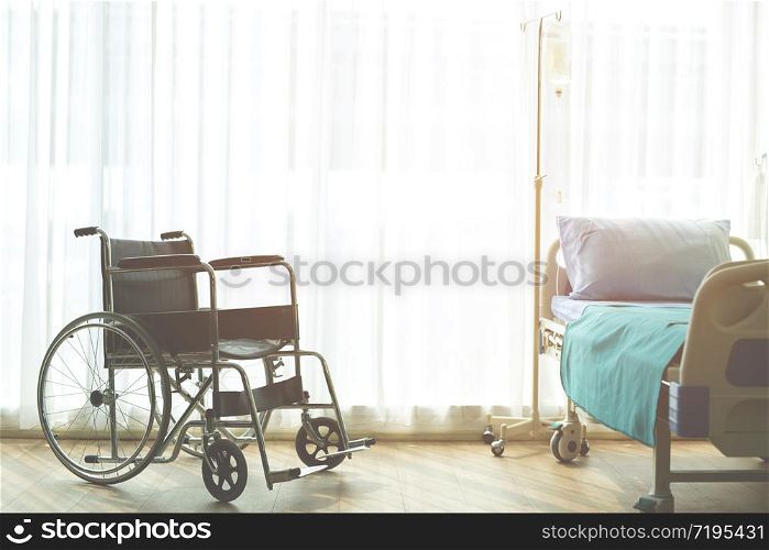 Wheelchair and Patient bed Iv saline bag infusion set and bottle on a pole. fluid saline drip hospital room or clinic. medical concept, treatment emergency shock. waiting for patient services.