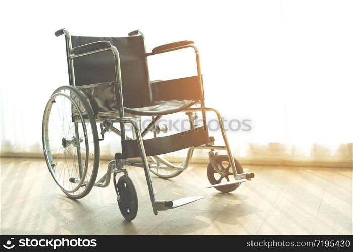 Wheelchair with morning sun by the window background in room hospital. Wheelchairs waiting for patient services. with copy space empty on right area.