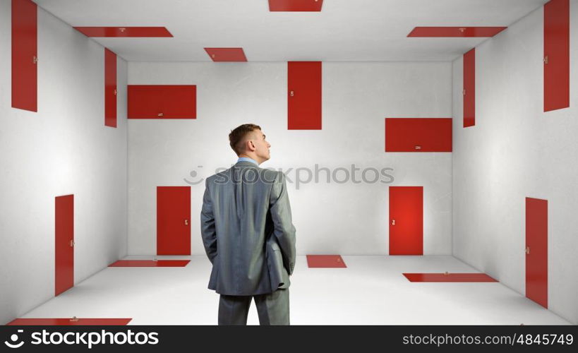 When making difficult decision. Businessman in room choosing one of plenty of doors