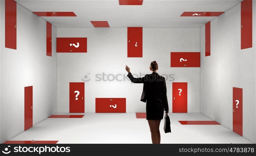 When making difficult decision. Businesswoman in room choosing one of plenty of doors