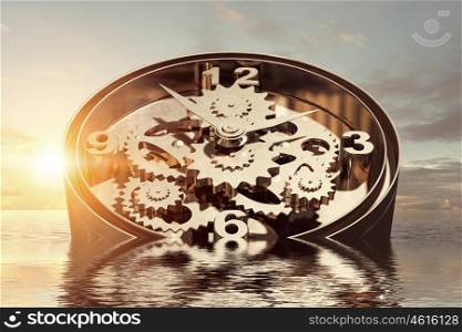 When time is passing. Time concept with clock mechanism drowning in water