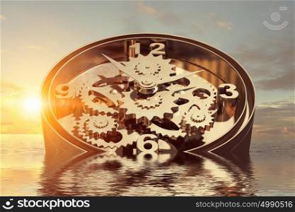 When time is passing. Time concept with clock mechanism drowning in water
