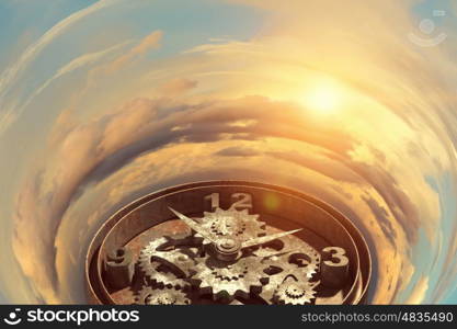 When time is passing. Time concept with old clock mechanism against sky background