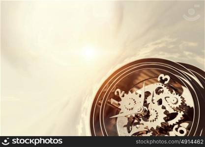 When time is passing. Time concept with old clock mechanism against sky background