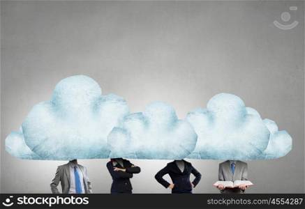 When working and thinking together. Group of business people with heads in clouds as teamwork concept