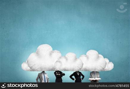 When working and thinking together. Group of business people with heads in clouds as teamwork concept