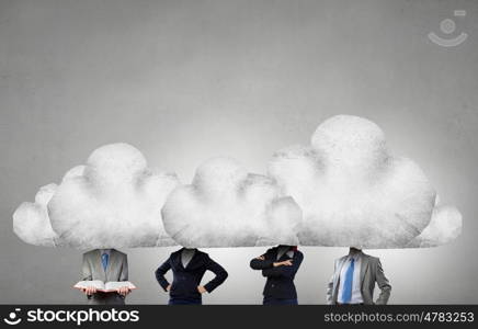 When working and thinking together. Group of business people with heads in clouds as teamwork concept