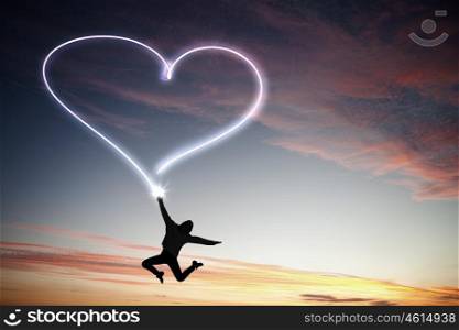 When you young and happy. Young girl jumping high in sky and drawing love sign