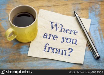 Where are you from question - handwriting on a napkin with a cup of espresso coffee