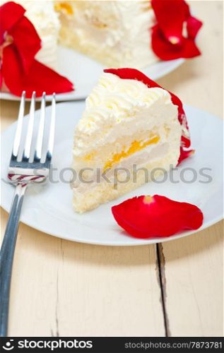 whipped cream mango cake with red rose petals