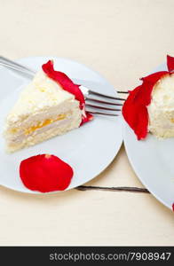 whipped cream mango cake with red rose petals