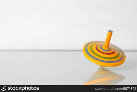 Whirligig in motion on white table