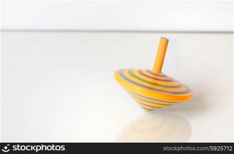 Whirligig in motion on white table