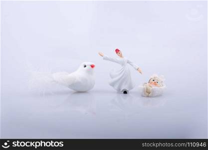 Whirling dervish by the side of a white bird on white background