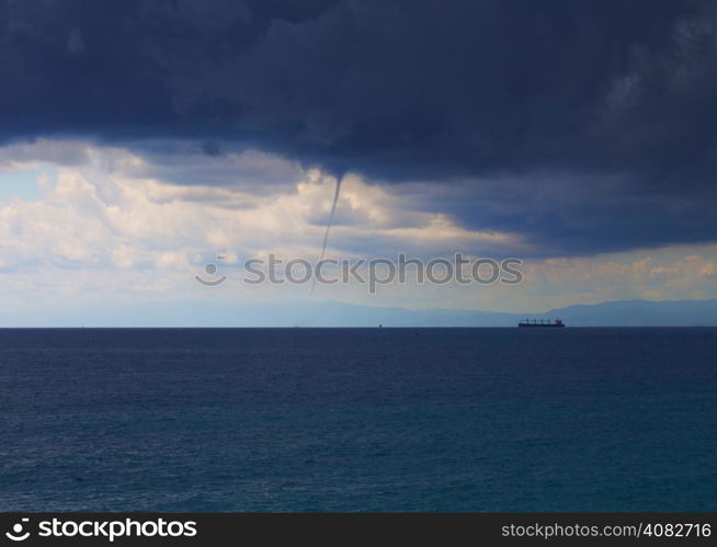 Whirlwind over the sea, with ships at the horizon