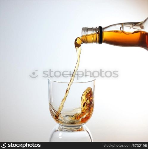 whiskey being poured into a glass