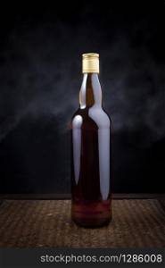 whiskey bottle on wood background use for multipurpose. whiskey bottle on wood background