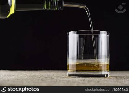 whiskey is poured into a glass