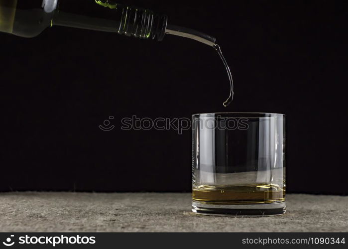 whiskey is poured into a glass