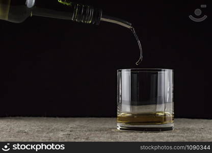 whiskey is poured into a glass