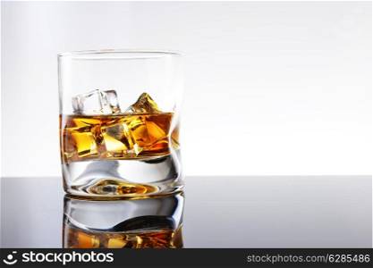 Whiskey with ice in simple glass