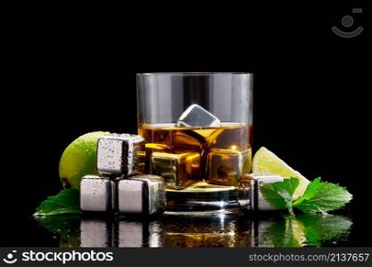 Whiskey with steel cooling cubes on dark glass background.. Whiskey with steel cooling cubes on dark glass background
