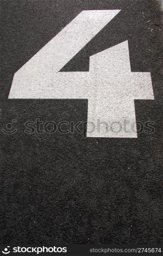 white 4 number sign painted on the asphalt road