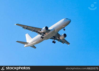 white airplane on a blue background. airplane in the sky