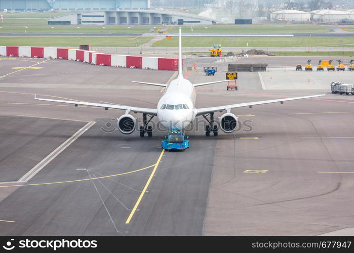 White Airplane waiting on taxiway ready to takeoff