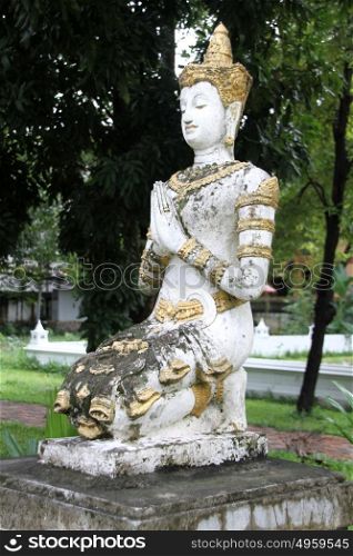 White ancient statue in the inner yard of wat, Chiang Mai, Thailand
