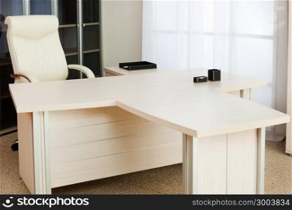 white and a large desk in a modern office