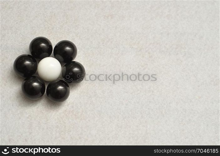 White and black balls packed in the shape of a flower isolated on a white background