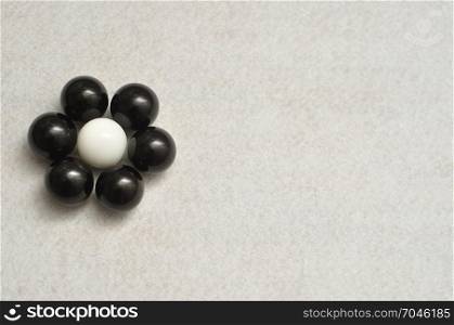 White and black balls packed in the shape of a flower isolated on a white background