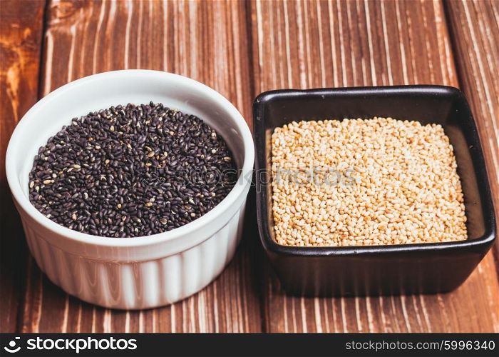 White and black fried sesame seeds in bowls. The Sesame seeds