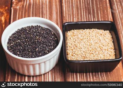 White and black fried sesame seeds in bowls. The Sesame seeds