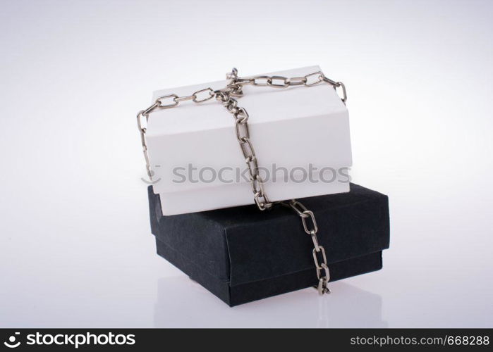 White and black gift boxes with chains on a white background