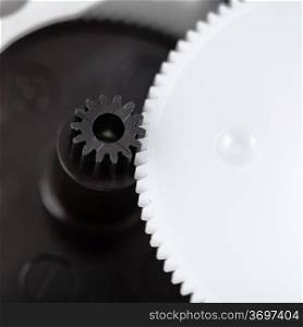 white and black plastic gears close up
