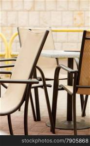 white and black restaurant chairs outdoor. Open cafe. Gastronomy services.