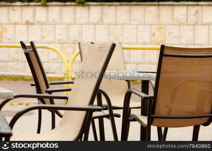 white and black restaurant chairs outdoor. Open cafe. Gastronomy services.