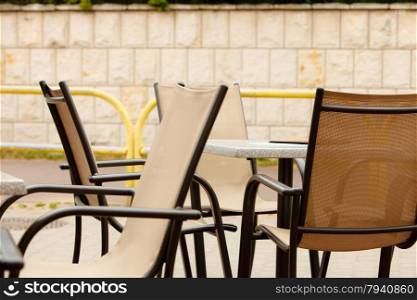 white and black restaurant chairs outdoor. Open cafe. Gastronomy services.