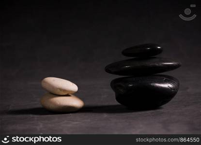 White and black stack of rocks isolated on black background