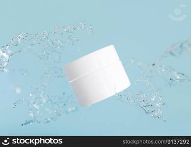White and blank, unbranded cosmetic cream jar with water splash. Skin care product presentation on blue background. Modern mock up. Jar with copy space. 3D rendering. White and blank, unbranded cosmetic cream jar with water splash. Skin care product presentation on blue background. Modern mock up. Jar with copy space. 3D rendering.