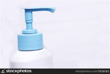 White and blue dispenser on the bottle of cleaning liquid