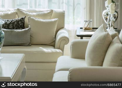 white and gray decorative pillows on a casual sofa in the living room