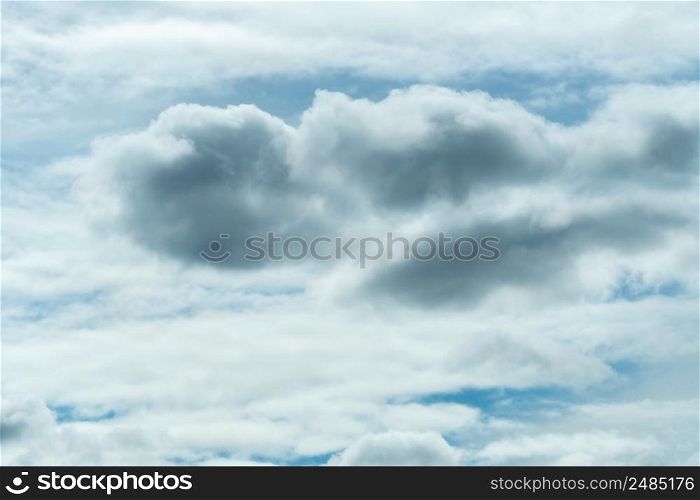 White and gray fluffy clouds on blue sky. Soft touch feeling like cotton. White puffy cloudscape. Beauty in nature. Close-up white clouds texture background. Cloudy sky. Background for tranquility.