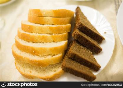 White and grey fresh bread on plate