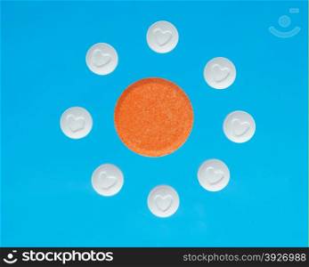 white and orange pills on a blue background