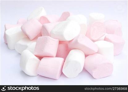 white and pink fluffy candies on gray background
