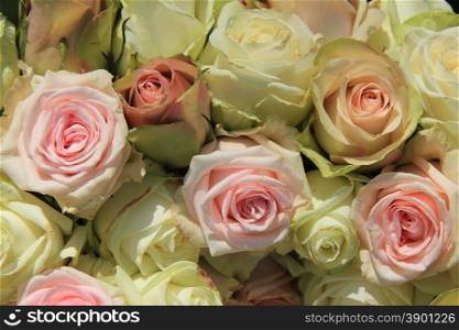 White and pink roses in a pastel wedding arrangement