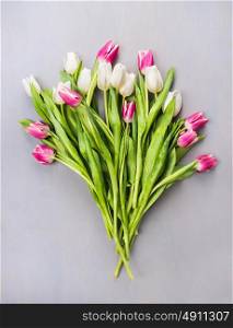 white and pink tulips Bouquet on gray wooden background , top view